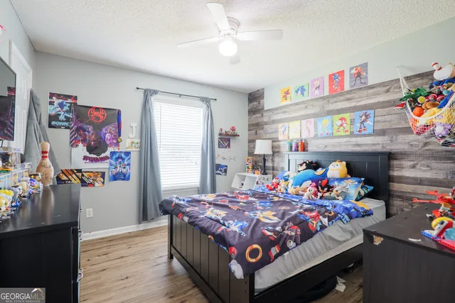 a bedroom with a bed and dresser