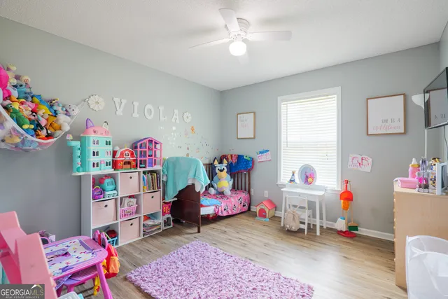 a living room with toys and a wooden floor