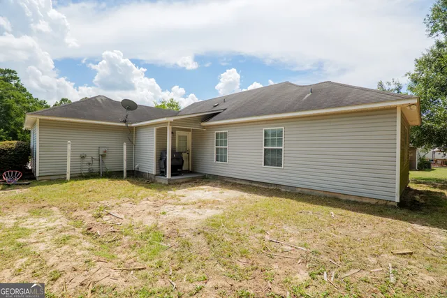 a view of a house with a yard and garage