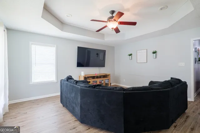 a living room with furniture and a flat screen tv