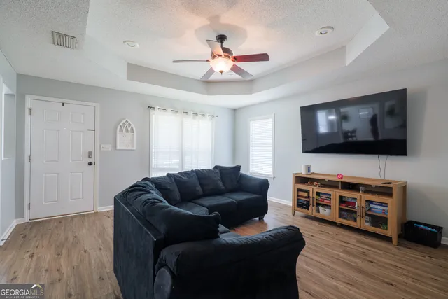 a living room with furniture and a flat screen tv