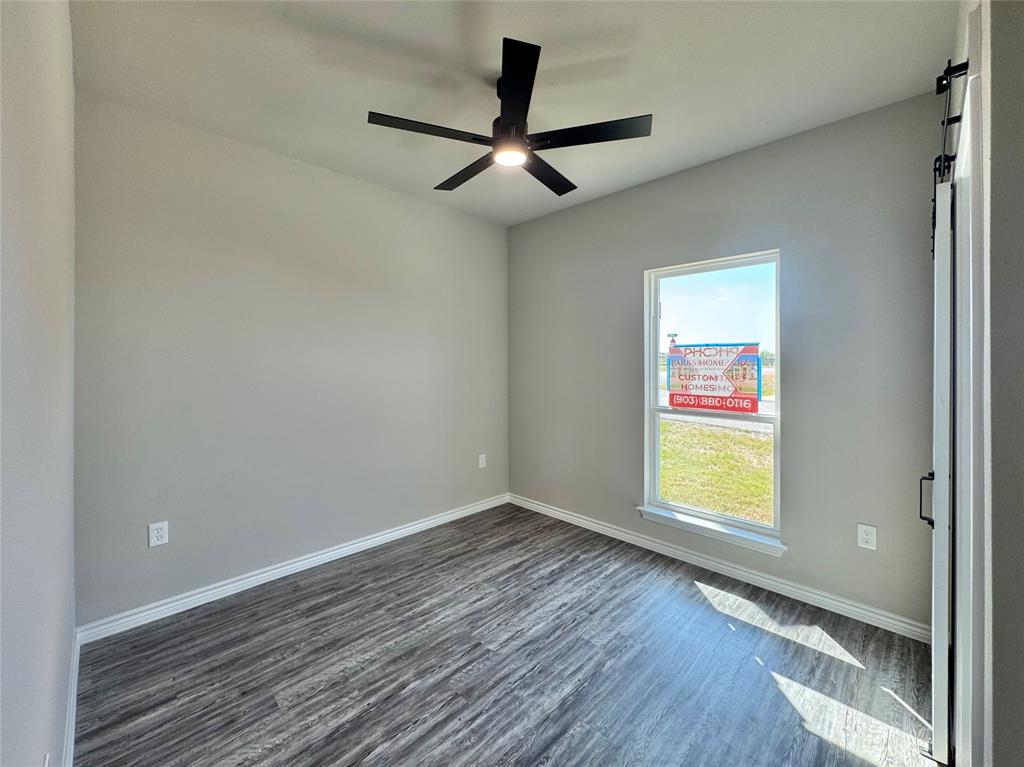 300 Rike Road Mabank, TX 75147 - Photo 11 of 18 wooden floor in an empty room with a window