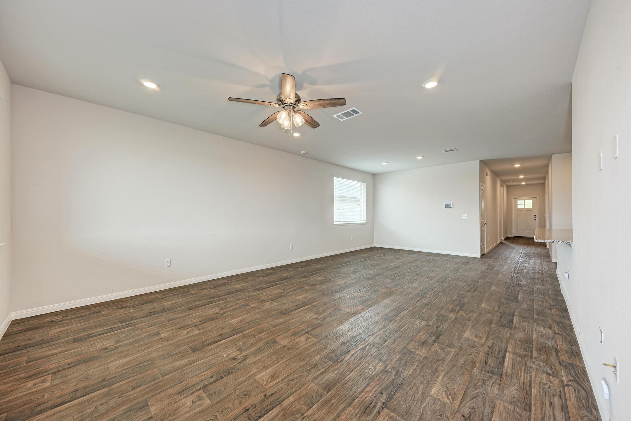208 Abby Road Georgetown, TX 78626 - Photo 23 of 40 a view of empty room with wooden floor and fan
