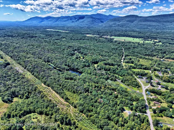 an aerial view of a house with a green yard