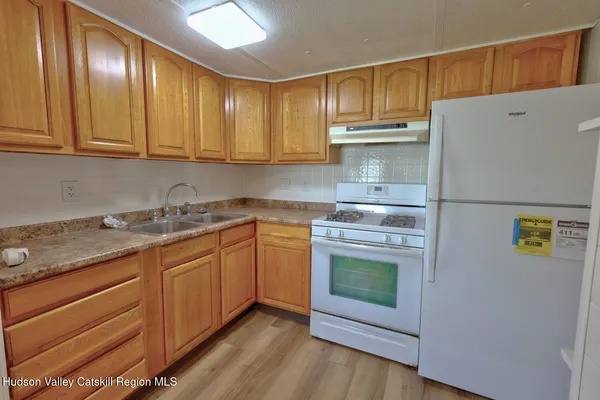 a kitchen with granite countertop a sink and cabinets