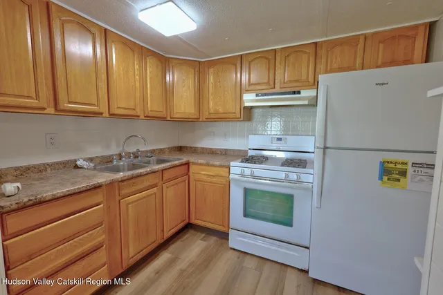 a kitchen with granite countertop a sink and cabinets