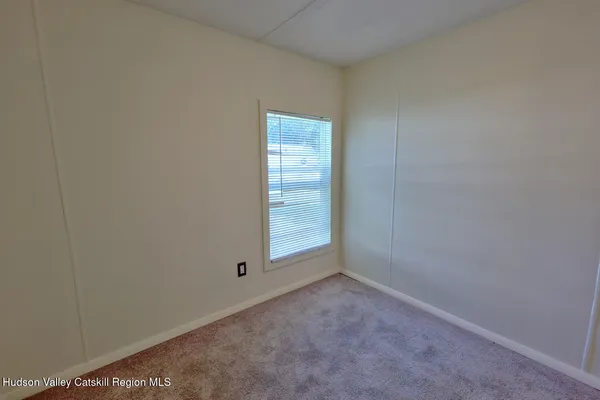 an empty room with closet area