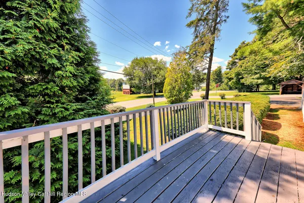 a view of backyard of house with wooden fence