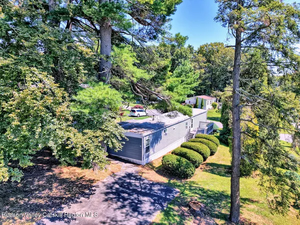 a backyard of a house with a yard and outdoor seating