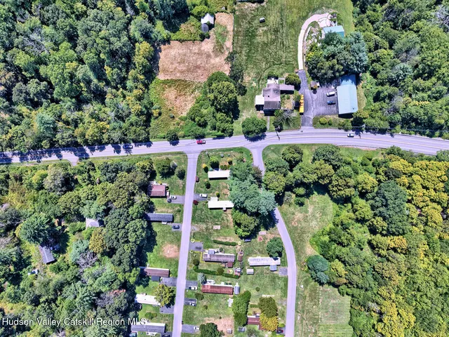 an aerial view of house with yard and swimming pool