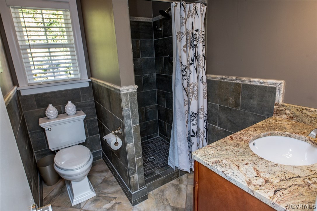 3402 Walkers Ferry Road Midlothian, VA 23112 - Photo 22 of 44 a bathroom with a granite countertop sink toilet and shower