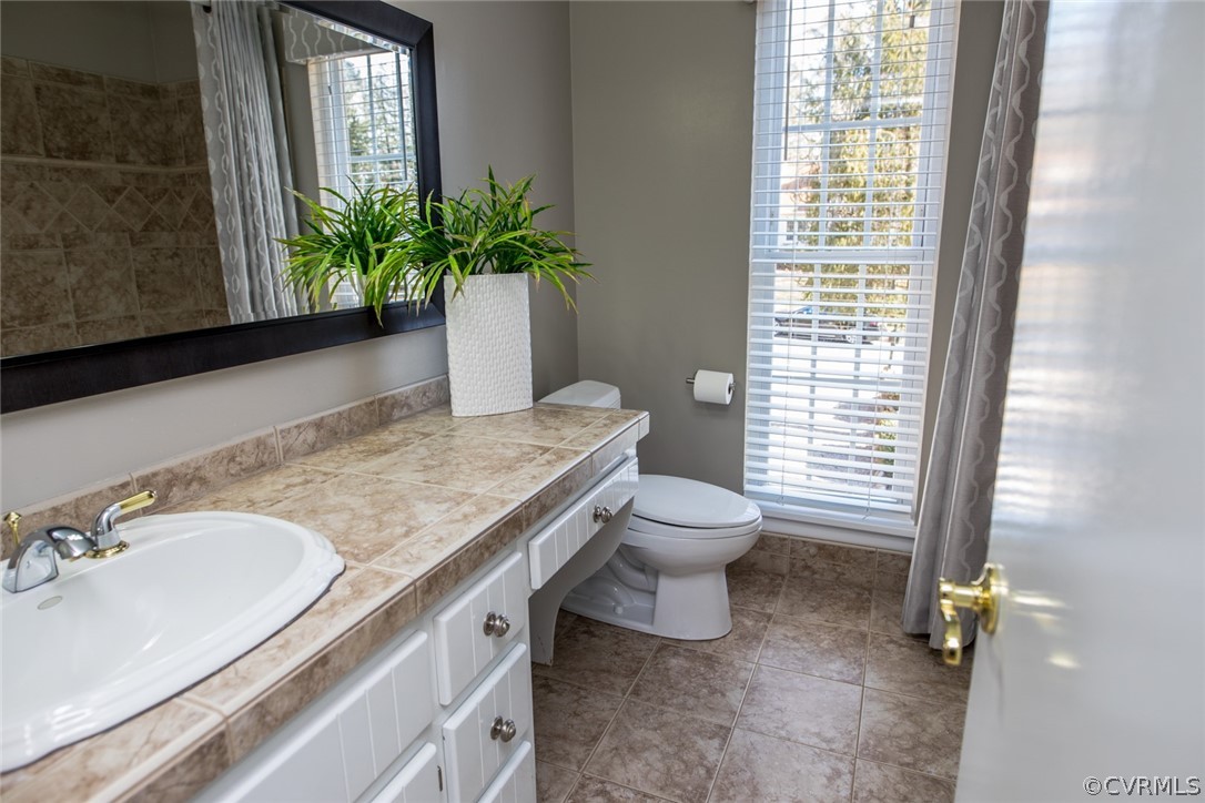 3402 Walkers Ferry Road Midlothian, VA 23112 - Photo 29 of 44 a bathroom with a granite countertop sink toilet and shower