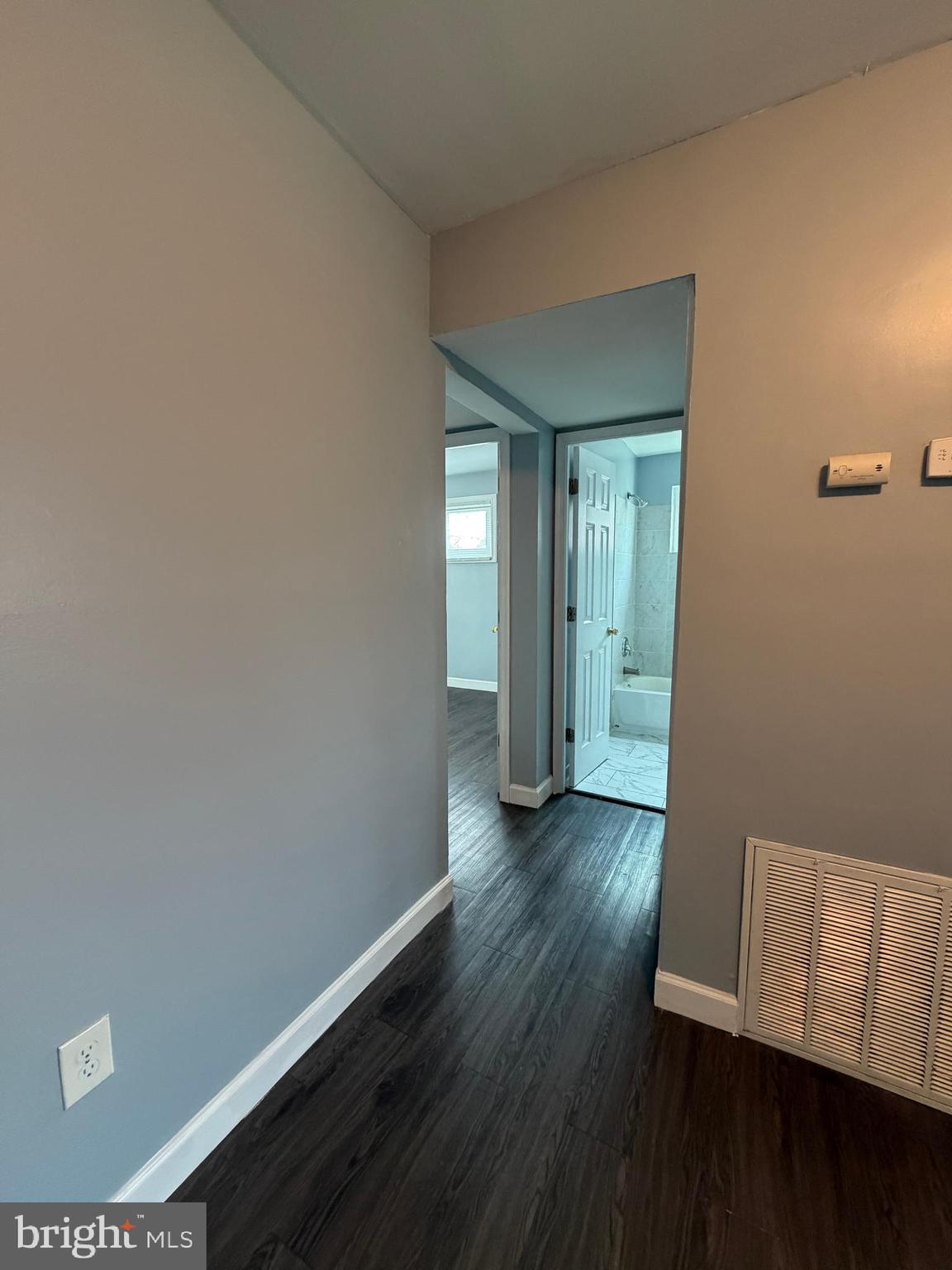 924 7th Street Laurel, MD 20707 - Photo 11 of 21 an empty room with wooden floor and mirror