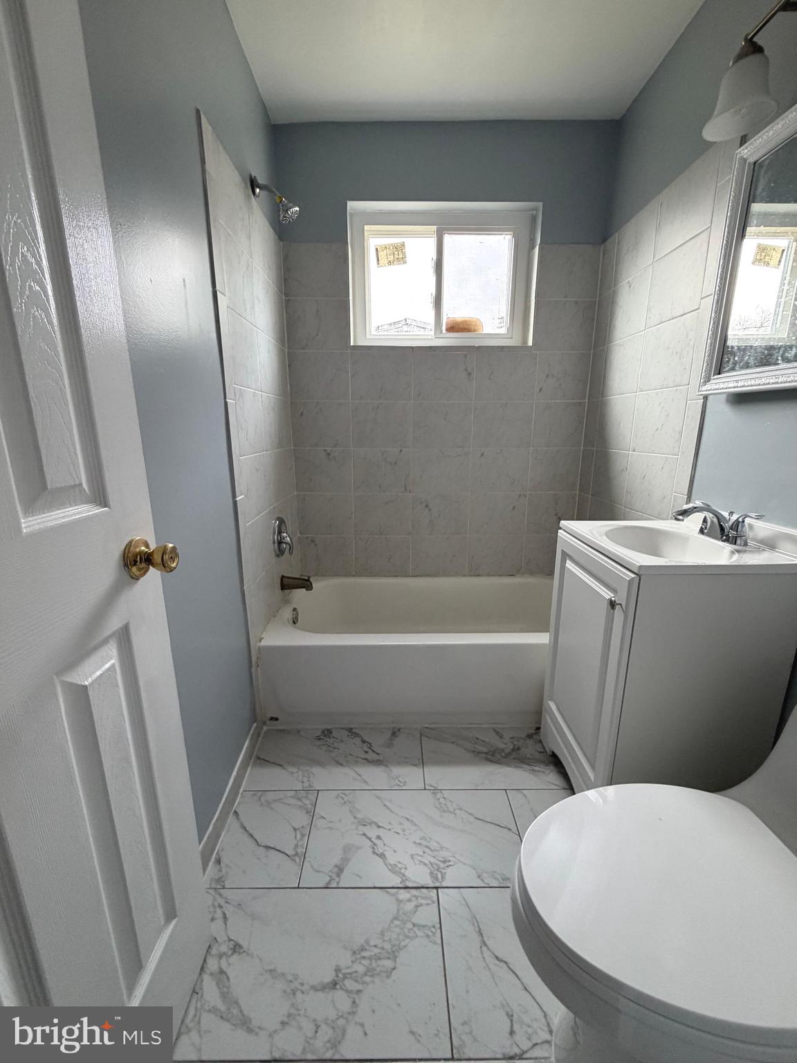 924 7th Street Laurel, MD 20707 - Photo 12 of 21 a bathroom with a toilet a sink and a bathtub