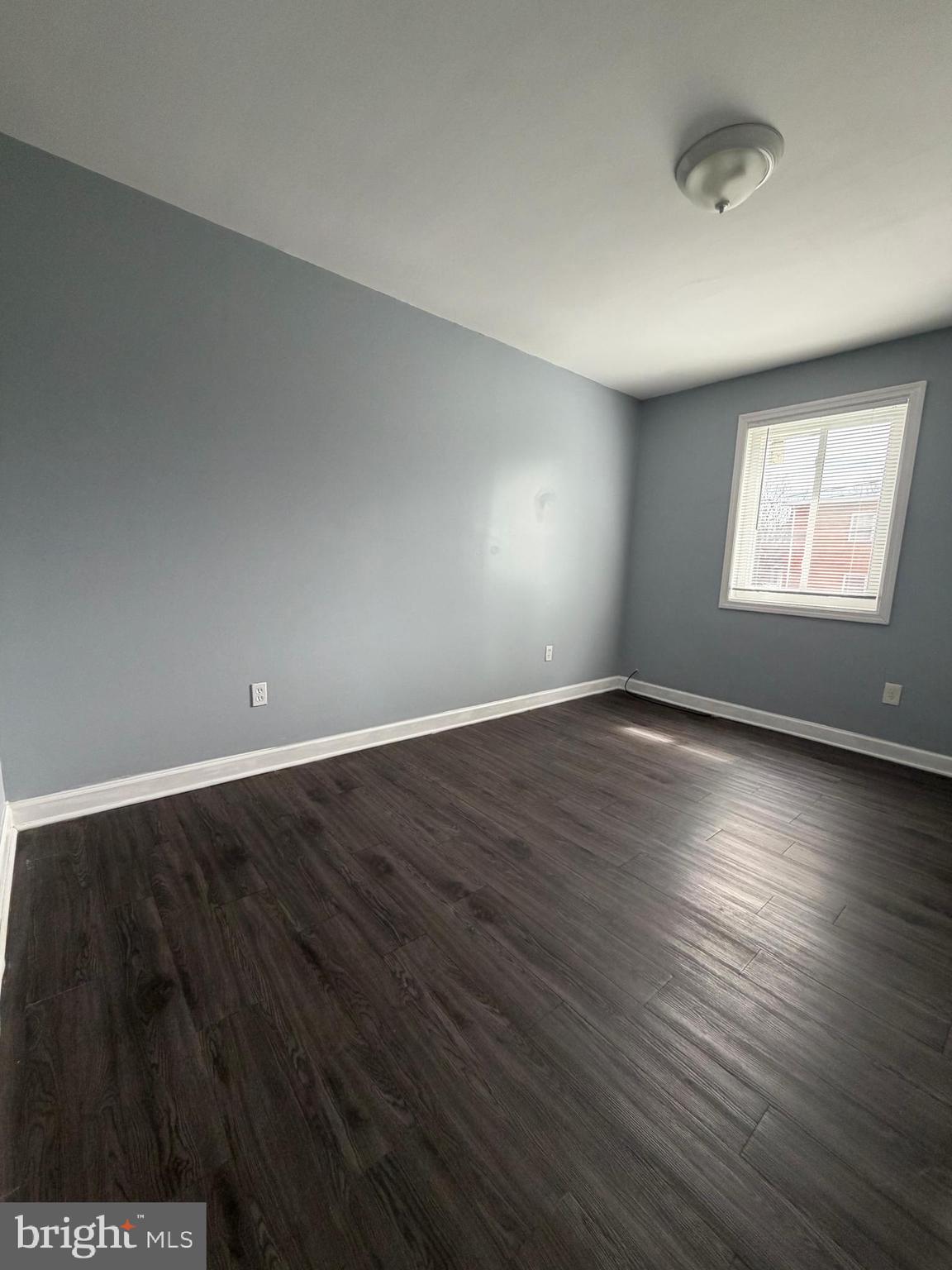 924 7th Street Laurel, MD 20707 - Photo 16 of 21 an empty room with wooden floor and windows