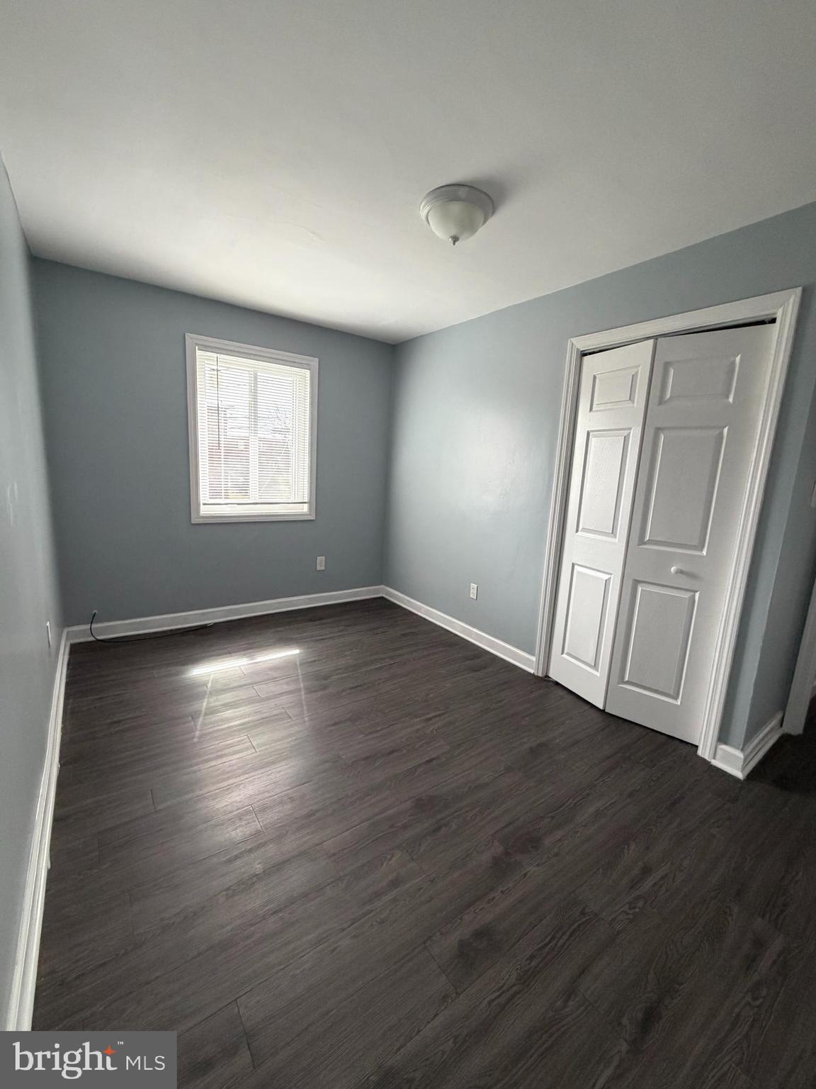 924 7th Street Laurel, MD 20707 - Photo 17 of 21 an empty room with wooden floor and windows