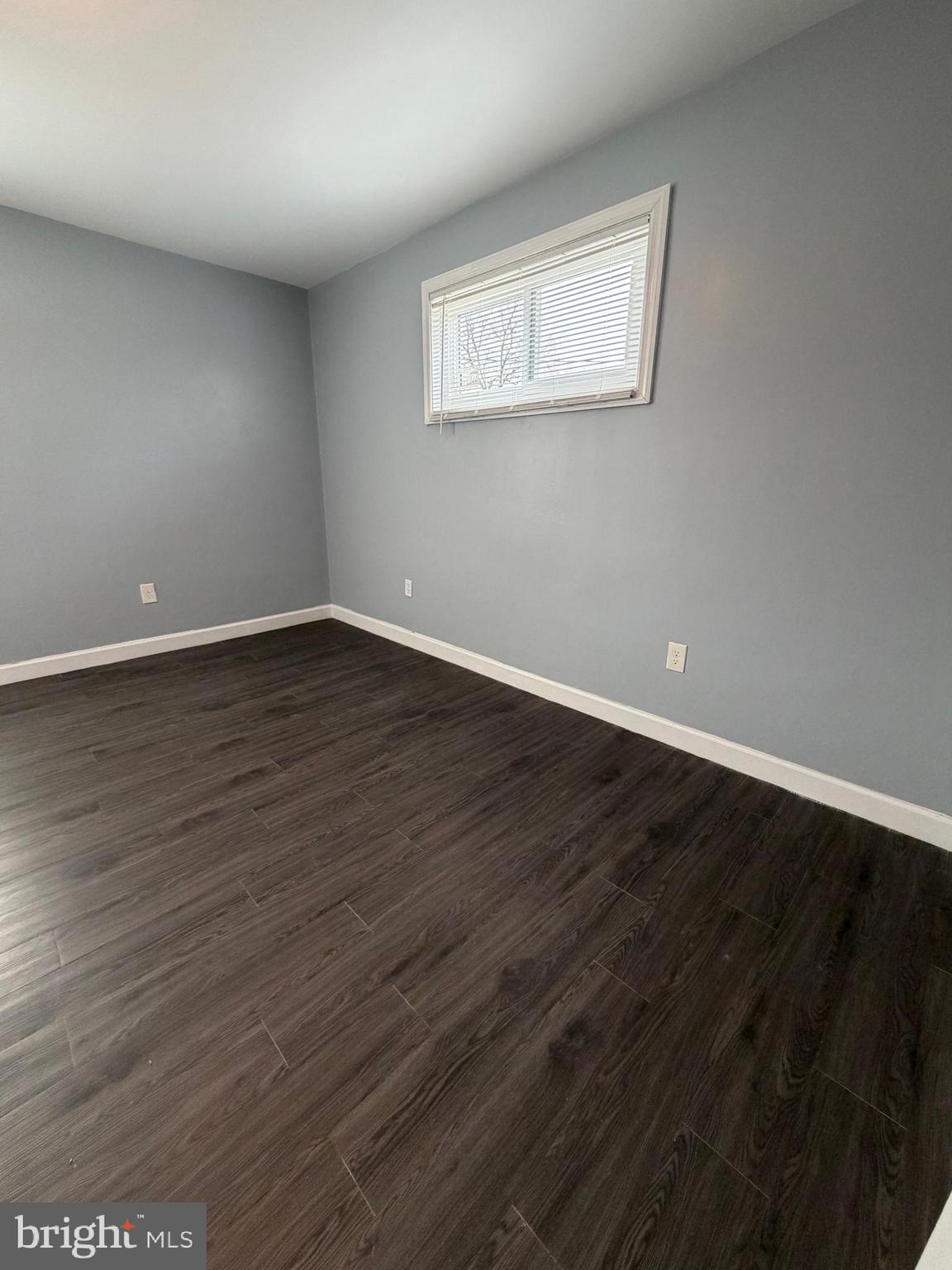 924 7th Street Laurel, MD 20707 - Photo 18 of 21 a view of an empty room with wooden floor and a window