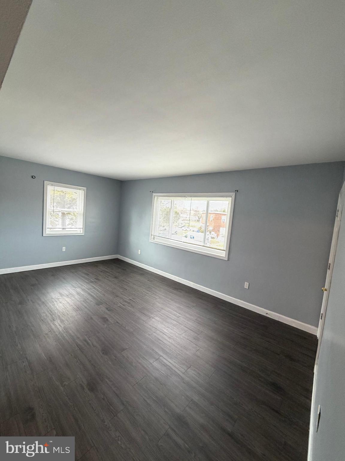 924 7th Street Laurel, MD 20707 - Photo 3 of 21 an empty room with wooden floor and windows