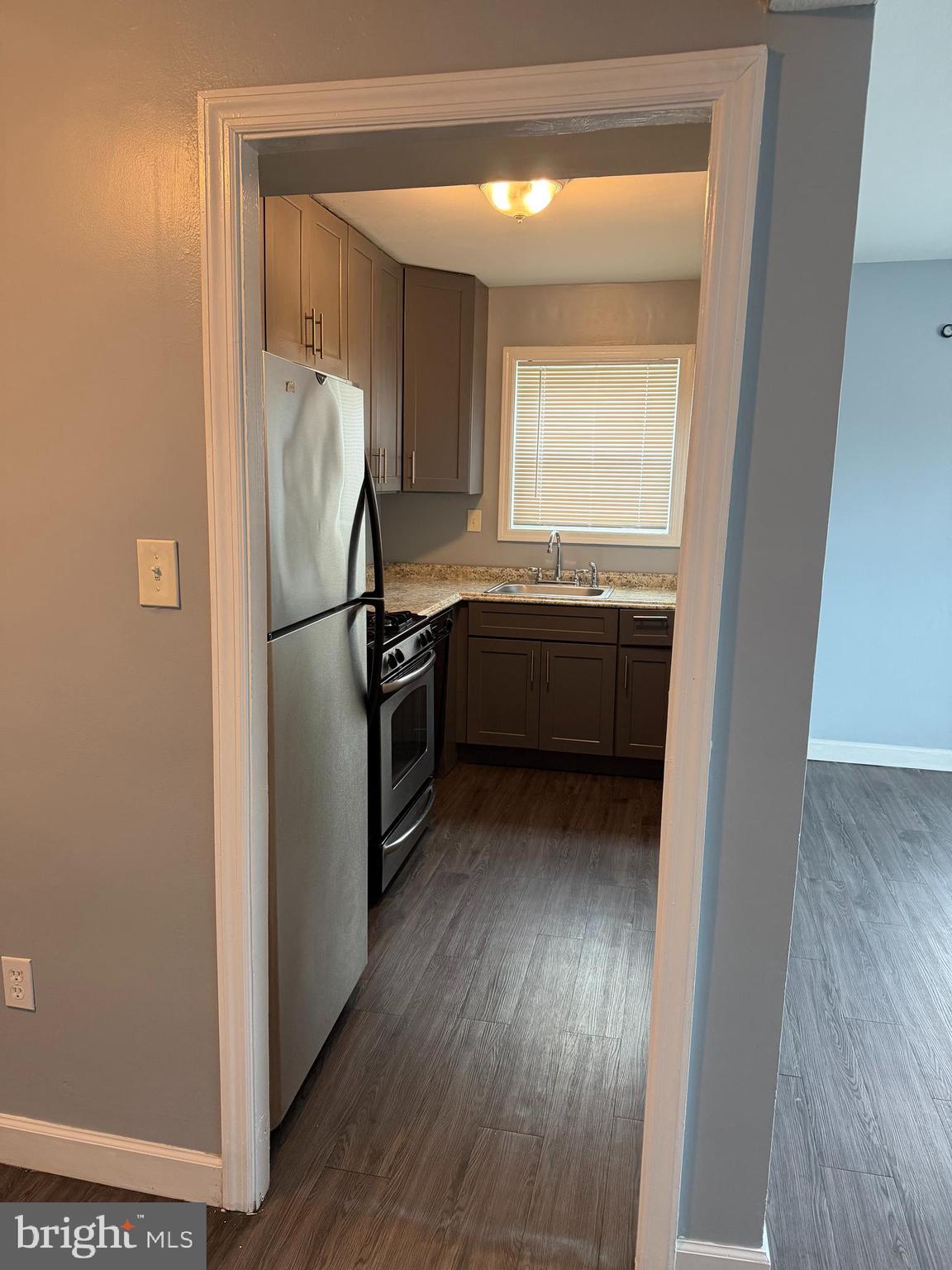 924 7th Street Laurel, MD 20707 - Photo 7 of 21 a view of kitchen with refrigerator and wooden floor