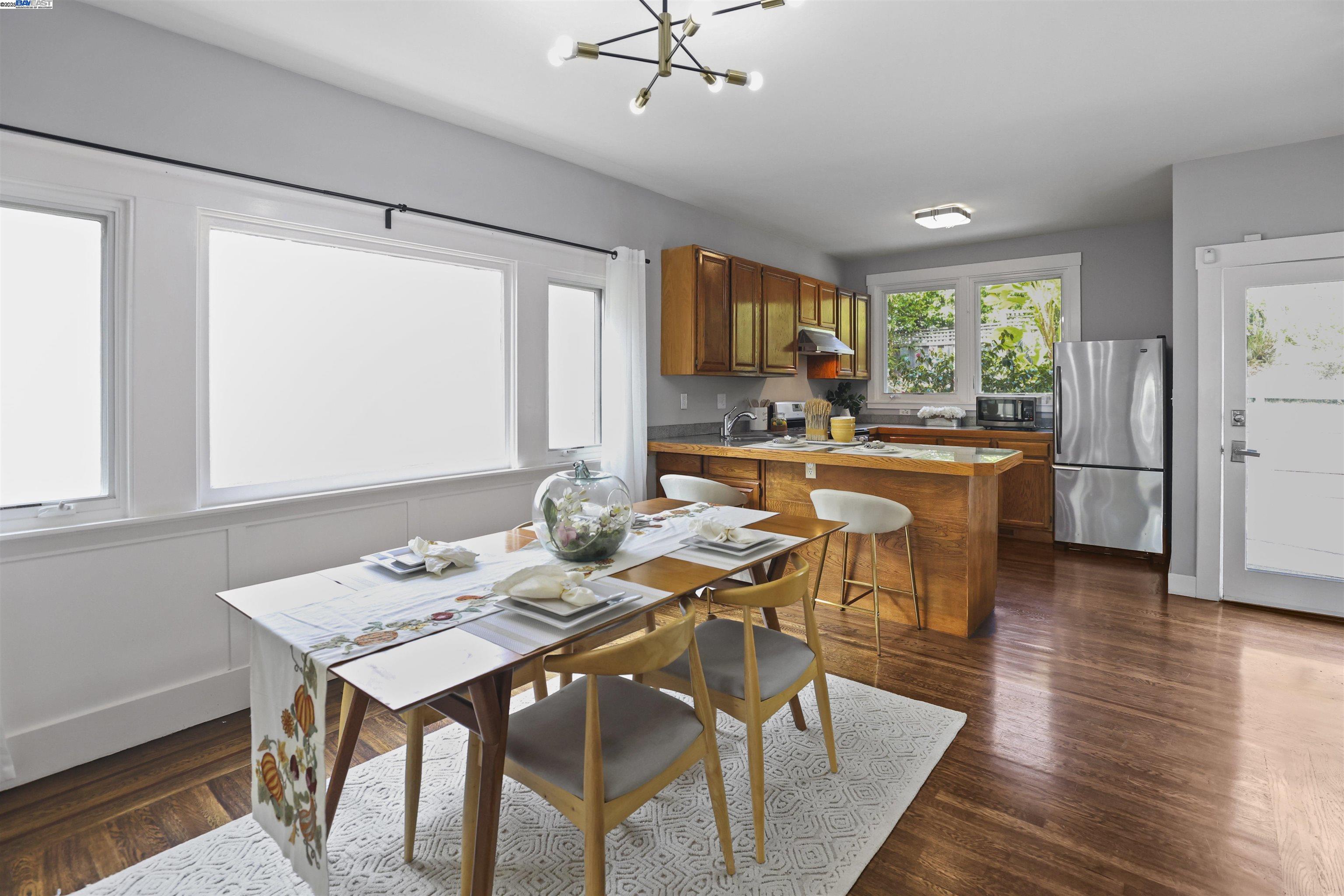 1361 Oakland Avenue Piedmont, CA 94611 - Photo 14 of 27 a view of a dining room with furniture window and wooden floor