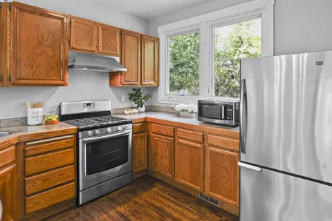 a bedroom with a bed and a painting on the wall
