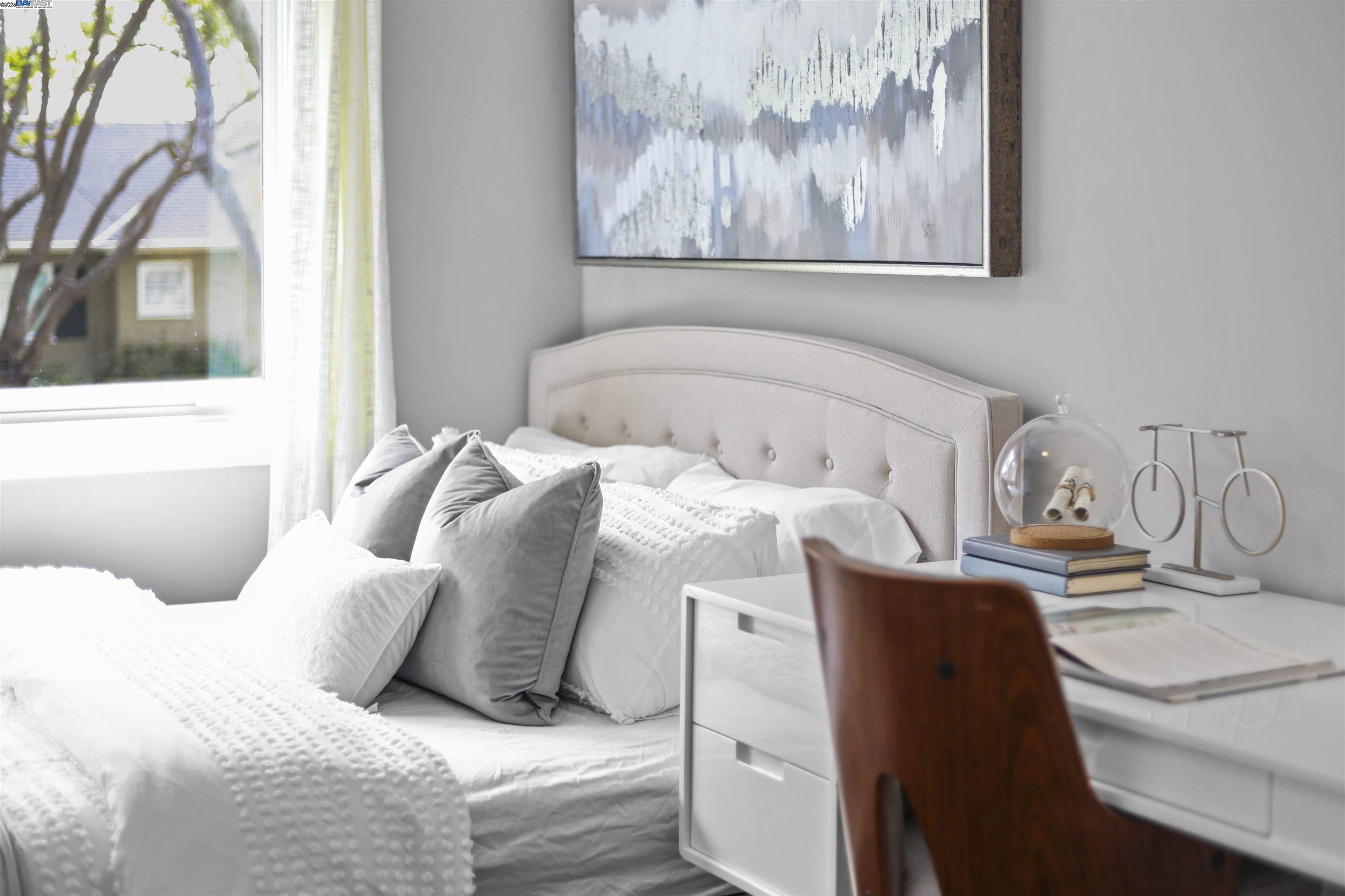 1361 Oakland Avenue Piedmont, CA 94611 - Photo 18 of 27 a bedroom with a bed and a painting on the wall