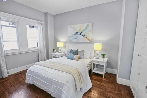 a bed sitting in a bedroom next to a window