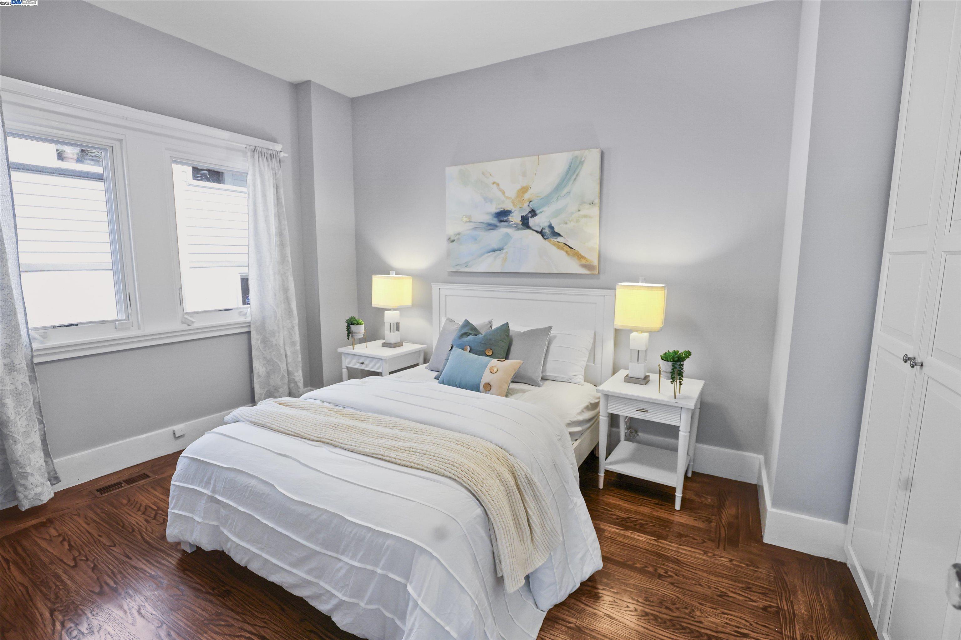 1361 Oakland Avenue Piedmont, CA 94611 - Photo 20 of 27 a bedroom with a bed and wooden floor