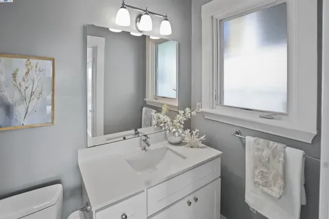 a bathroom with a granite countertop sink a toilet and a bathtub