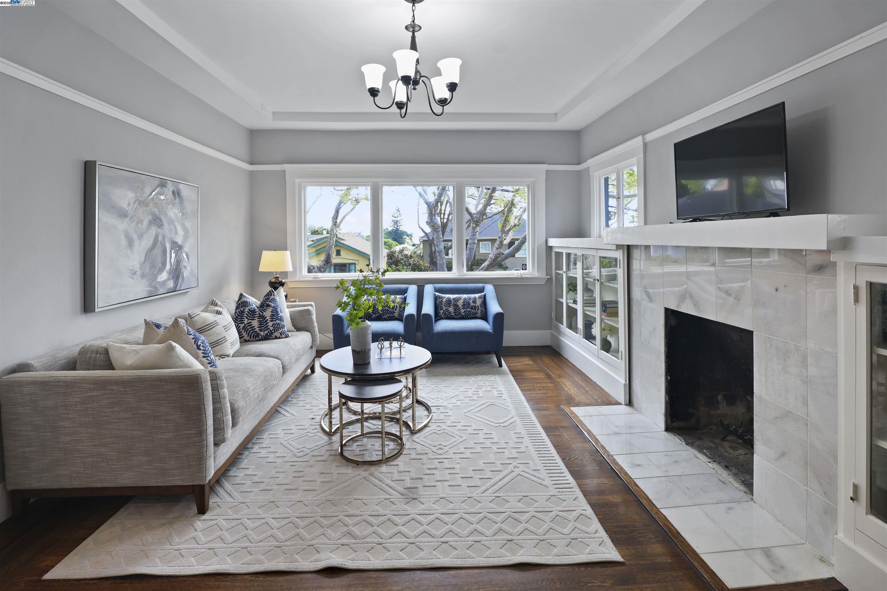1361 Oakland Avenue Piedmont, CA 94611 - Photo 3 of 27 a living room with furniture a flat screen tv and a fireplace