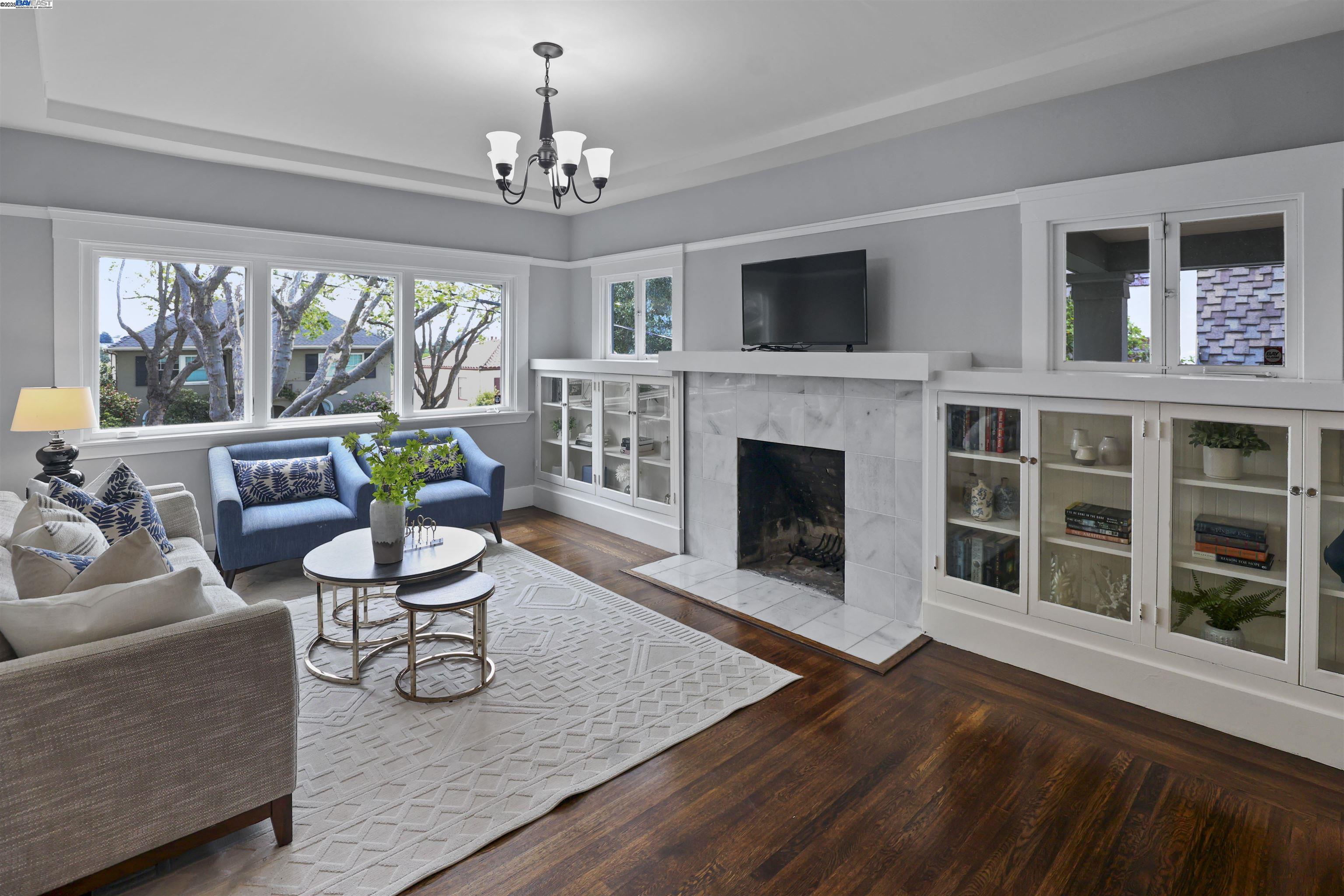 1361 Oakland Avenue Piedmont, CA 94611 - Photo 5 of 27 a living room with furniture a fireplace and a flat screen tv
