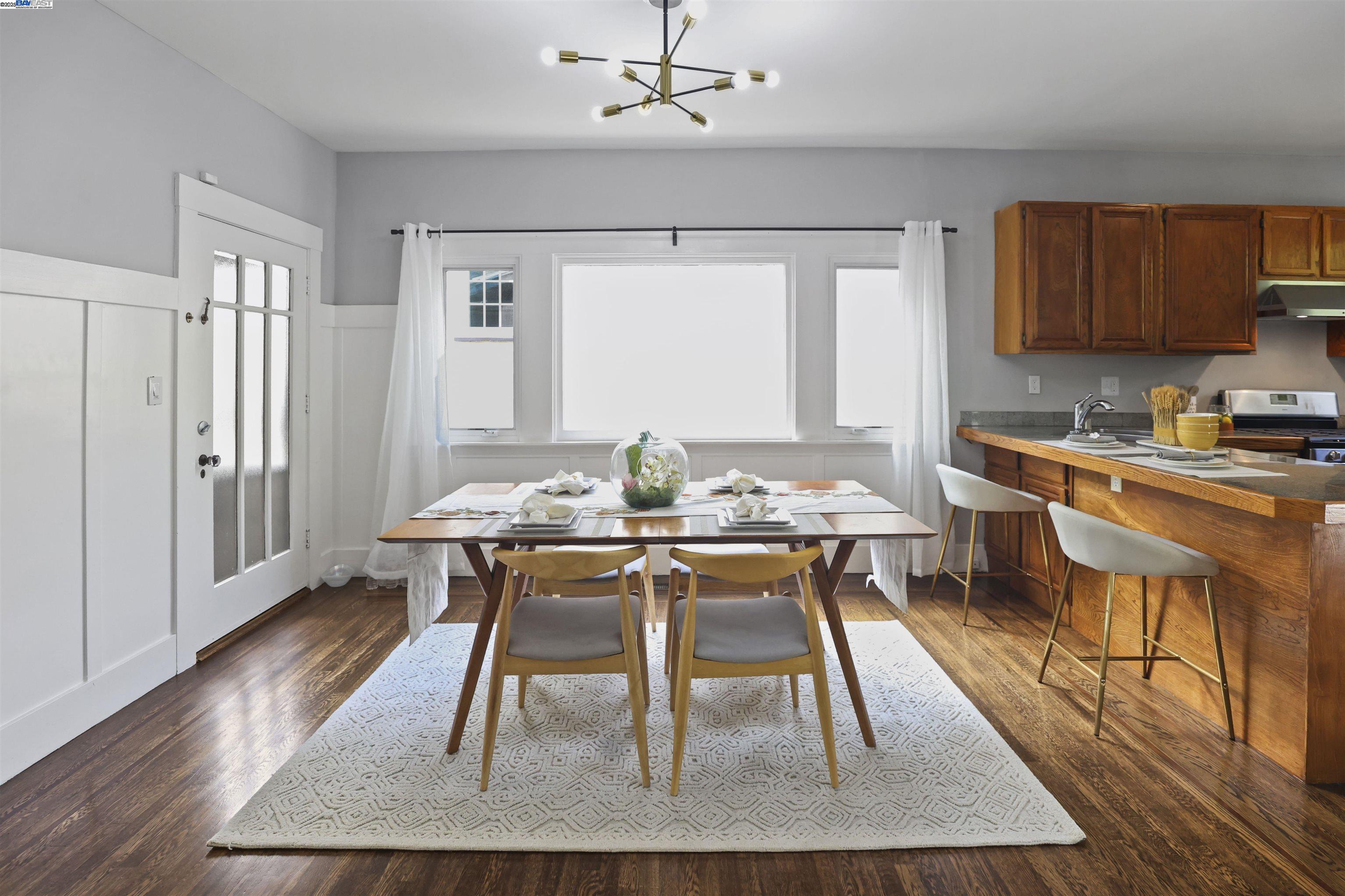1361 Oakland Avenue Piedmont, CA 94611 - Photo 10 of 27 a dining room with wooden floor and white walls