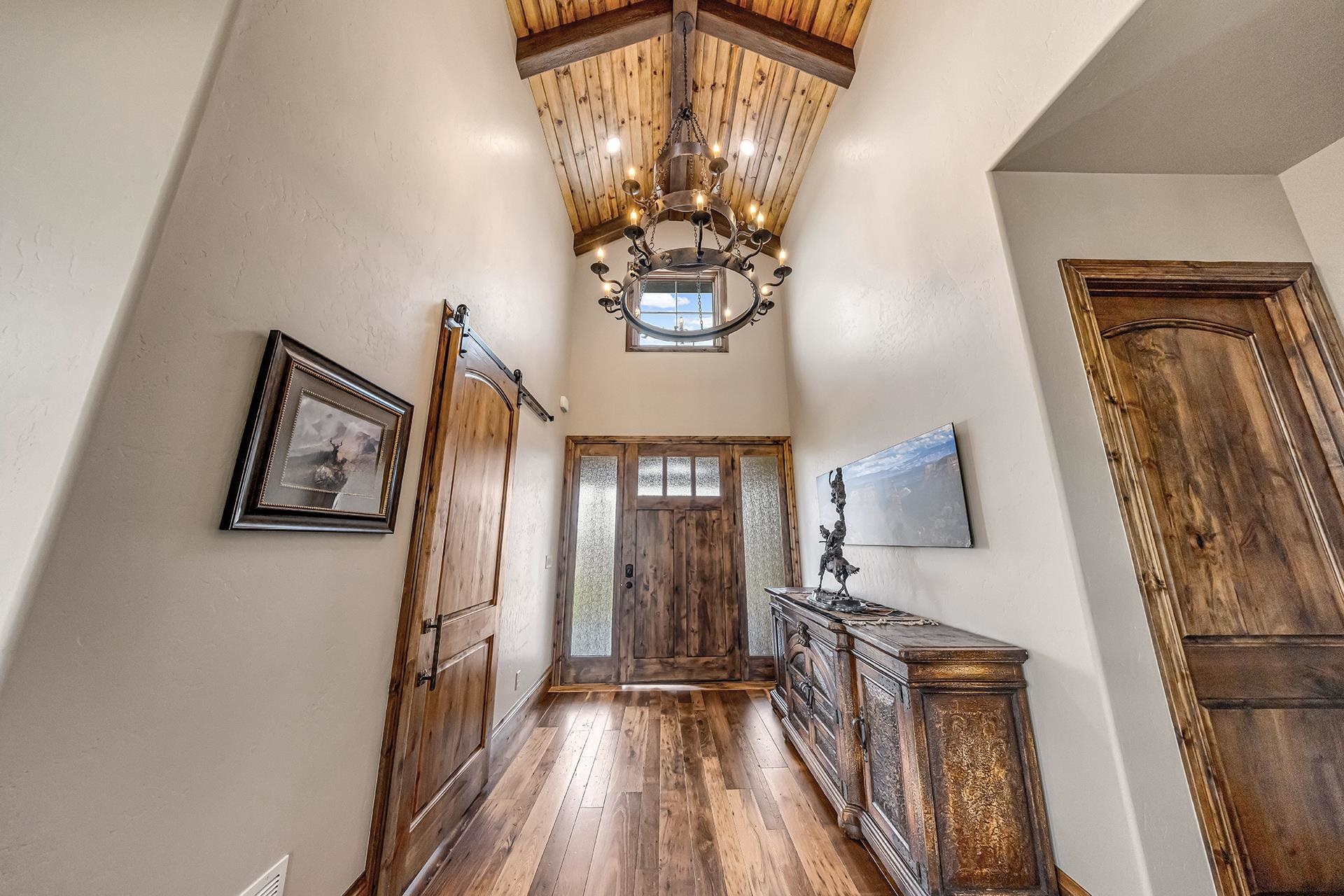 2440 J Road Grand Junction, CO 81505 - Photo 7 of 42 a view of a hallway with wooden floor and staircase