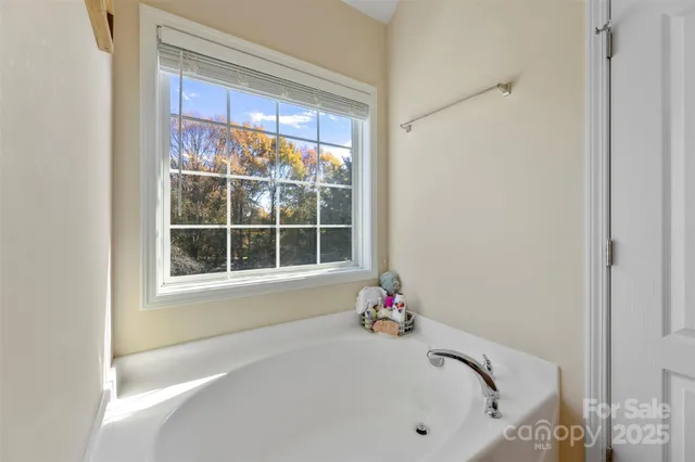 a white bath tub sitting next to a window