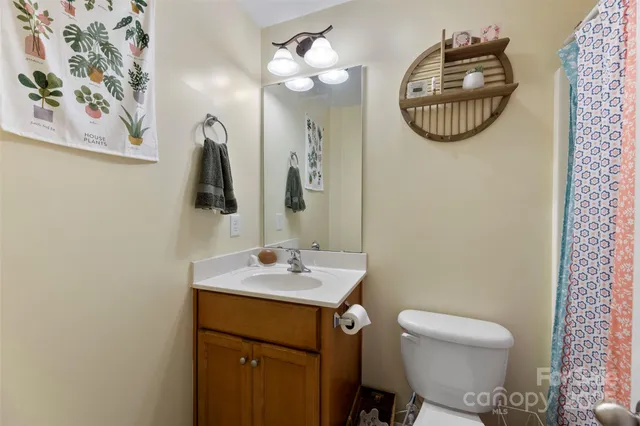 a bathroom with a sink vanity mirror and toilet