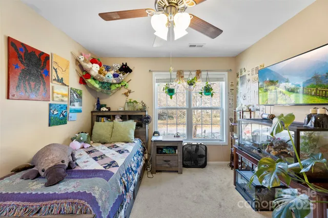 a bedroom with bed and a chandelier