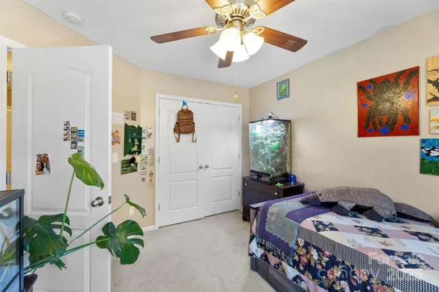a bedroom that has a bed and a chandelier