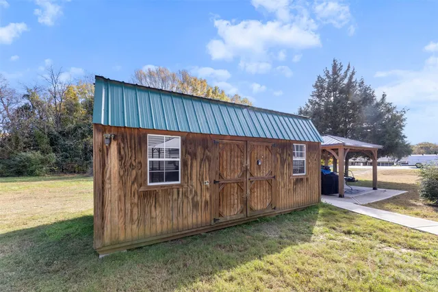 a view of a backyard with wooden fence