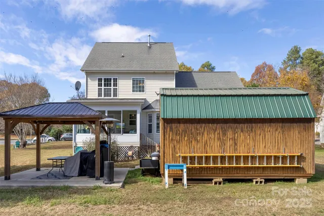 a view of a house with a yard and sitting area