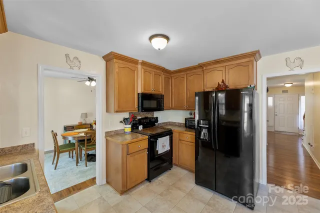 a kitchen with stainless steel appliances granite countertop a refrigerator stove and sink