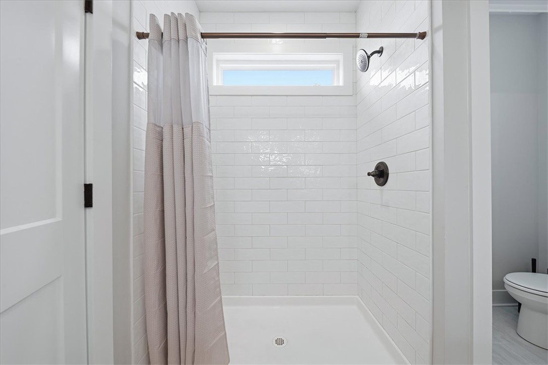 214 Timothy Court Anderson, SC 29621 - Photo 30 of 43 A well-lit shower features classic white subway tile and modern fixtures.