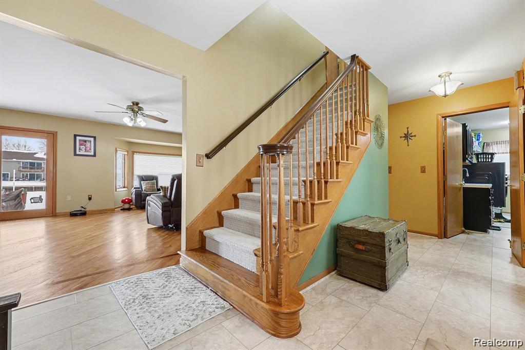7277 Cardinal Road Algonac, MI 48001 - Photo 13 of 36 Stairway with ceiling fan and tile patterned flooring