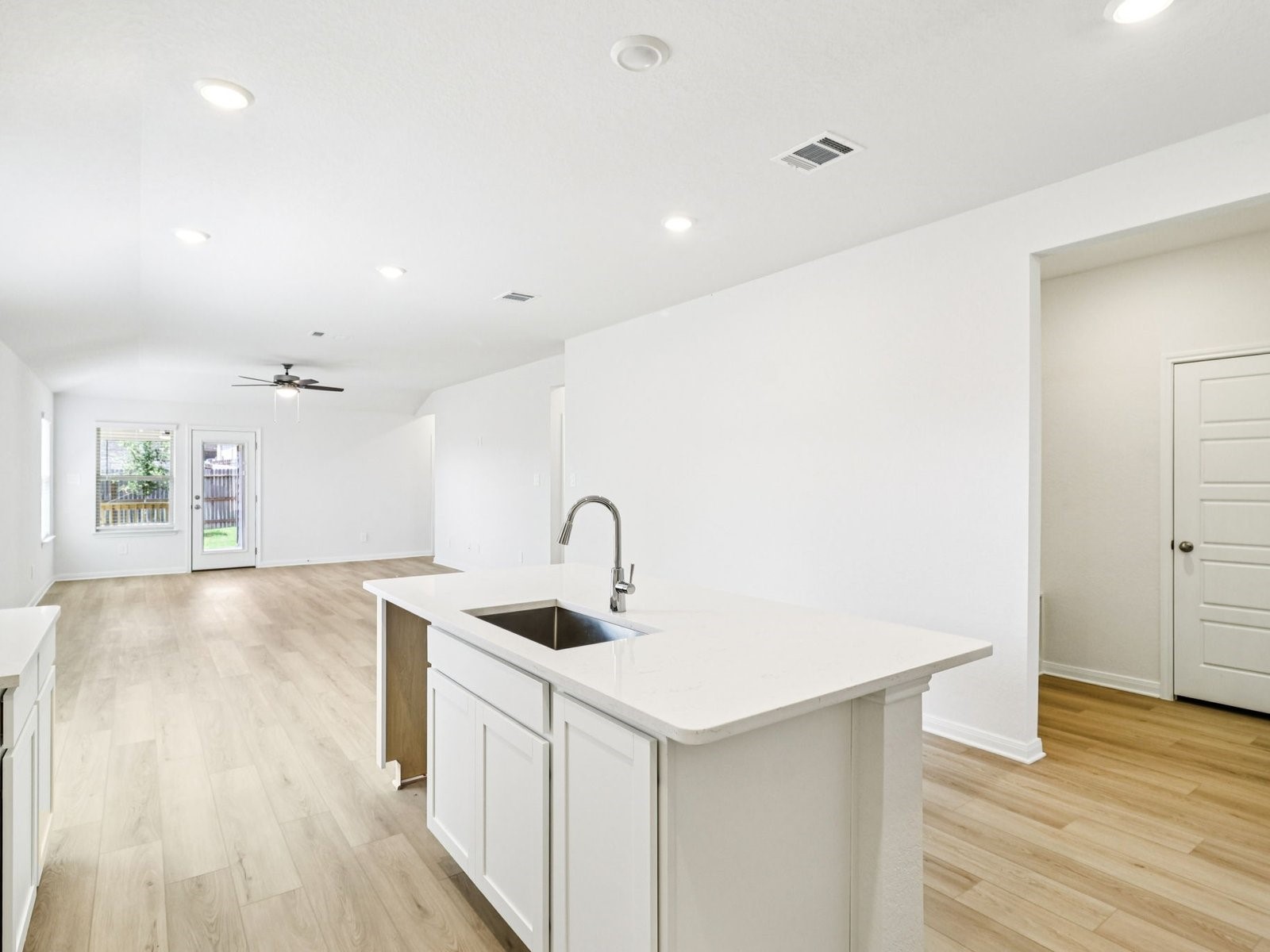 16258 Parish Pointe Court Conroe, TX 77302 - Photo 2 of 10 a kitchen with stainless steel appliances granite countertop a sink and dishwasher with wooden floor