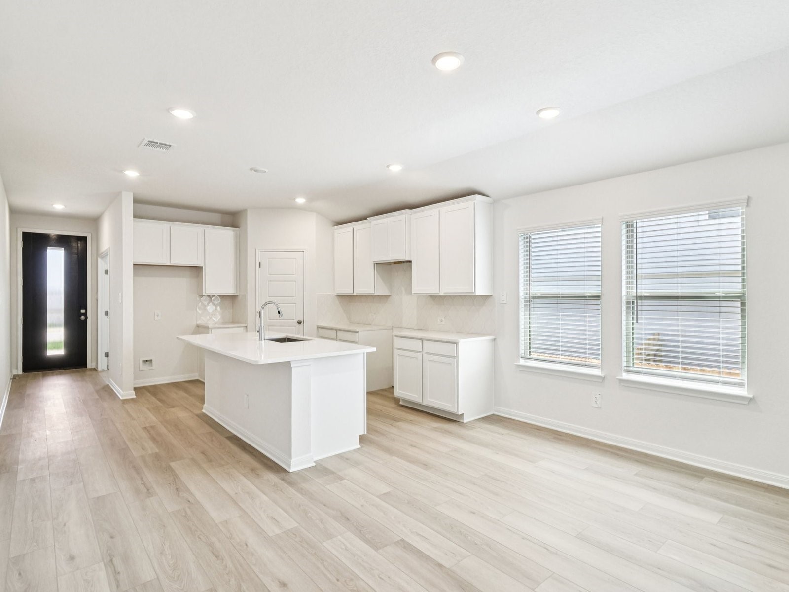 16258 Parish Pointe Court Conroe, TX 77302 - Photo 3 of 10 a large kitchen with a large counter top a sink stainless steel appliances and cabinets