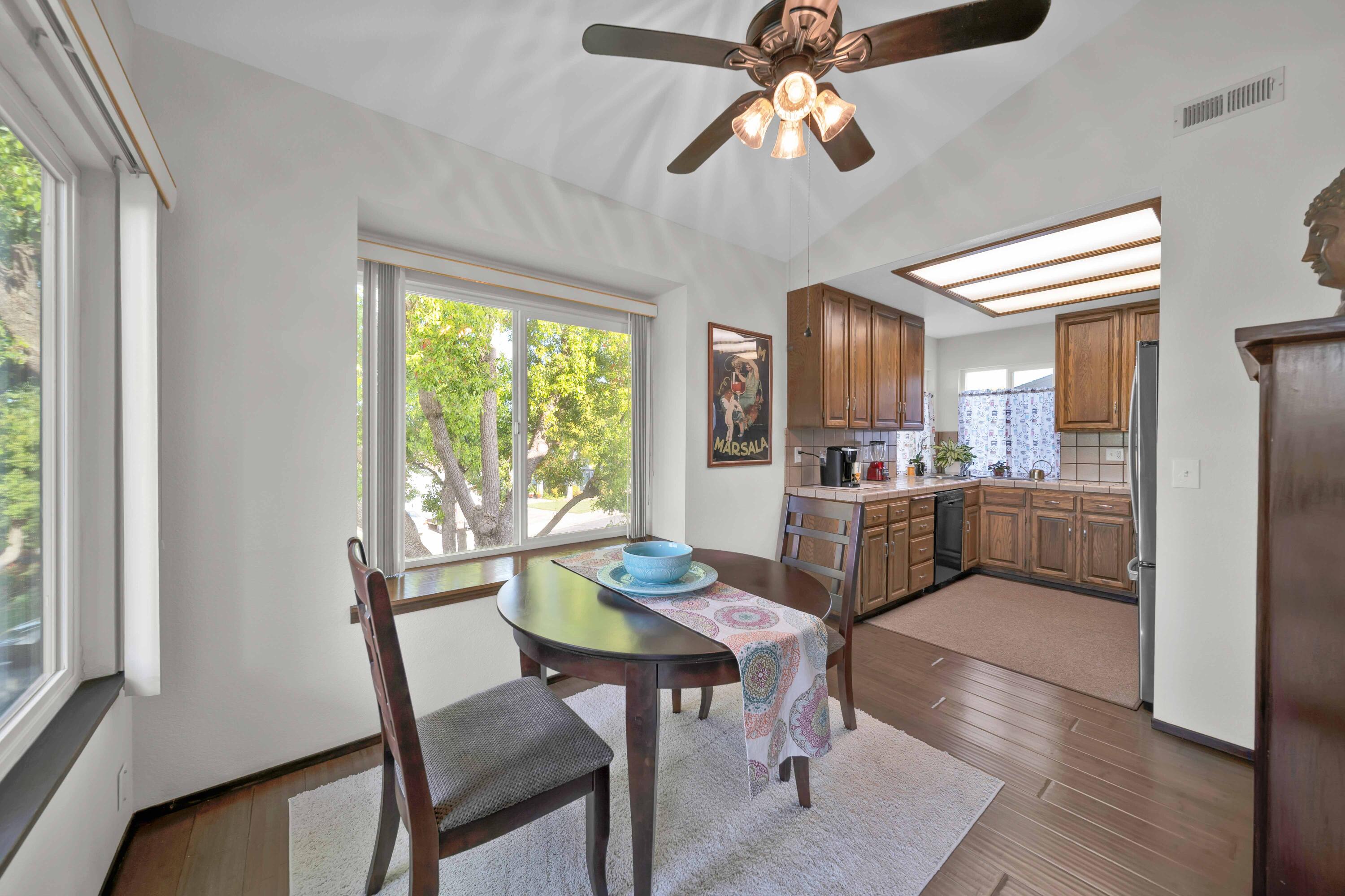 249 Ridgetop Drive, Unit 239 Redding, CA 96003 - Photo 10 of 31 a kitchen with a dining table chairs and refrigerator