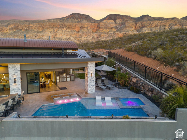 3652 South Cypress Road Hurricane, UT 84737 - Photo 73 of 81 Expansive backyard with a rectangular pool, integrated spa, and an outdoor kitchen area