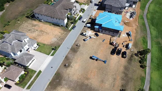 an aerial view of a house with a yard and parking space