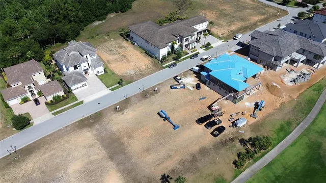 an aerial view of a house with a yard and basket ball court