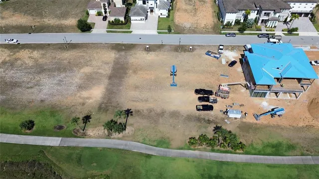 an aerial view of a house with a yard