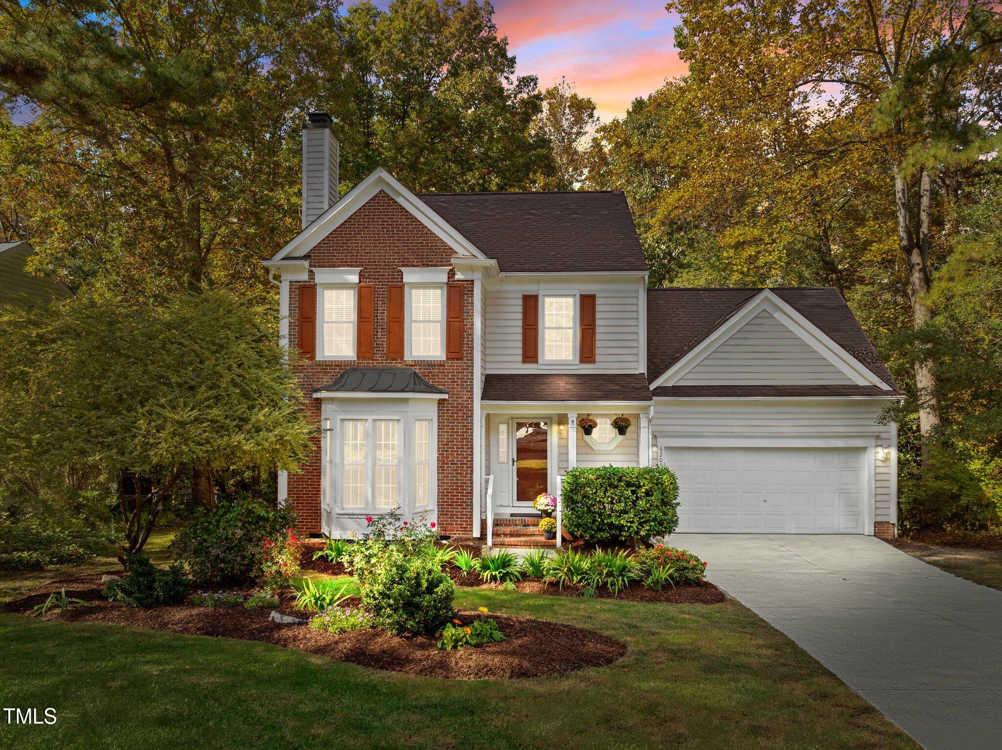 6209 Brielson Place Raleigh, NC 27616 - Photo 1 of 41 a front view of a house with a yard and garage